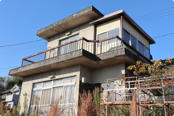 青空の下に建つ木造の空き家